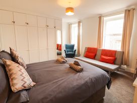 A bedroom with a bed and sofa at 7 Lonsdale Terrace in Penrith