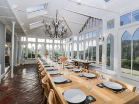 A dining room with a long table set for a meal at Valley View in Dalton-In-Furness