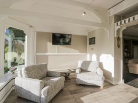 A snug with armchairs and a television at Valley View in Dalton-In-Furness