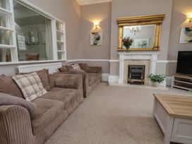 A living room with a sofa and television at Bridlington Bay House in Bridlington
