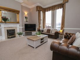 A living room with a sofa, coffee table, and television at Bridlington Bay House in Bridlington