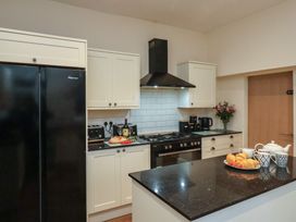 A kitchen with a refrigerator, stove, and sink at Bridlington Bay House in Bridlington