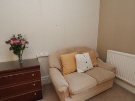 A sofa with pillows and a flower vase at Bridlington Bay House in Bridlington