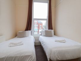 A bedroom with two beds and a window at Bridlington Bay House in Bridlington