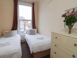 A bedroom with two beds and a dresser at Bridlington Bay House in Bridlington