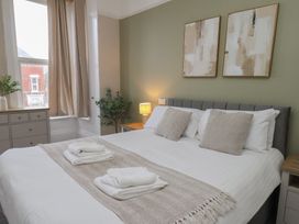 A bedroom with a bed and bedside table at Bridlington Bay House in Bridlington