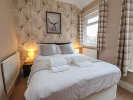 A bedroom with a bed and bedside table at Bridlington Bay House in Bridlington