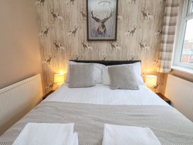A bedroom with a bed and bedside lamps at Bridlington Bay House in Bridlington