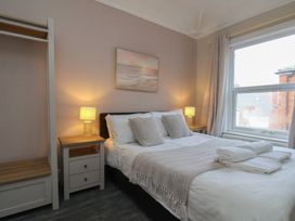 A bedroom with a bed and nightstand at Bridlington Bay House in Bridlington