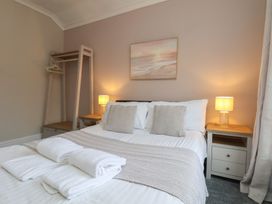 A bedroom with a bed and bedside tables at Bridlington Bay House in Bridlington