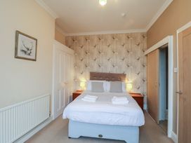 A bedroom with a bed and side tables at Bridlington Bay House in Bridlington