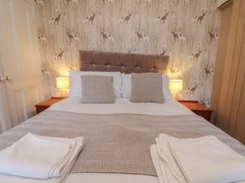 A bedroom with a bed and curtains at Bridlington Bay House in Bridlington