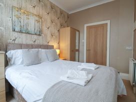 A bedroom with a bed and wardrobe at Bridlington Bay House in Bridlington