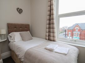 A bedroom with a single bed and window view at Bridlington Bay House in Bridlington