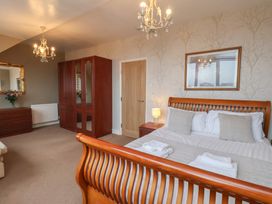 A bedroom with a bed and dresser at Bridlington Bay House in Bridlington