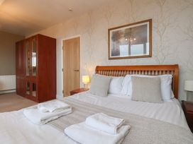 A bedroom with a bed and wardrobe at Bridlington Bay House, Bridlington