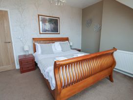 A bedroom with a bed and nightstand at Bridlington Bay House in Bridlington
