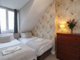 A bedroom with two beds and a dresser at Bridlington Bay House in Bridlington