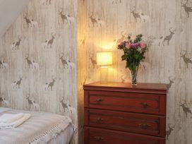 A bedroom with a chest of drawers and a lamp at Bridlington Bay House in Bridlington