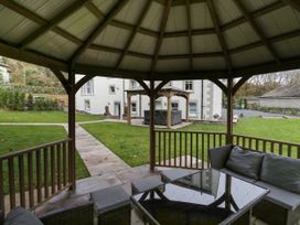 A garden with a gazebo and seating area at Beechgrove Manor in Workington