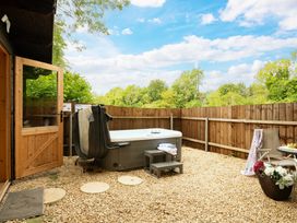 A garden with a hot tub and seating area at Hazel in Blandford Forum