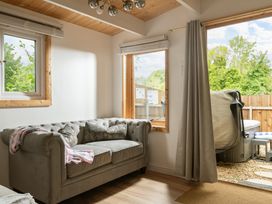 A snug with a sofa and hot tub visible at Hazel in Blandford Forum