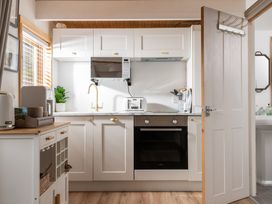 A kitchen with cabinets and appliances at Hazel in Blandford Forum