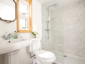 A bathroom with a shower, sink, and toilet at Hazel in Blandford Forum