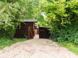 An outdoor area with a shed and a gate at Hazel in Blandford Forum