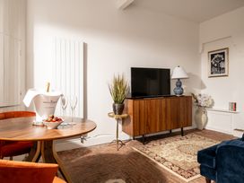 A living room with a television and a round table at Stable in Blandford Forum
