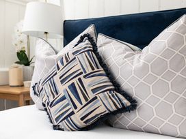 A collection of pillows on a bed at Stable in Blandford Forum