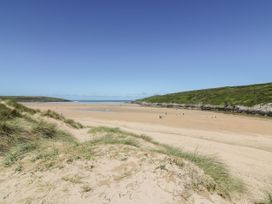 A beach with sand and ocean in the background at Newquay Tamarisk Lodge on the Gannel Newquay