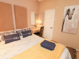 A bedroom with a bed and desk at Rosie's Zen Den in High Hesket near Armathwaite