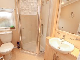 A bathroom with a shower, toilet, and sink at Rosie's Zen Den in High Hesket near Armathwaite