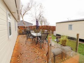 An outdoor area with a table and chairs at Rosie's Zen Den High Hesket near Armathwaite