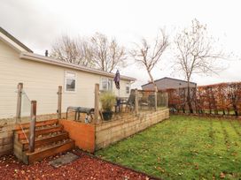 A garden with steps and seating area at Rosie's Zen Den in High Hesket near Armathwaite