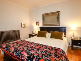 A bedroom with a bed and bedside tables at Sea View, St Austell