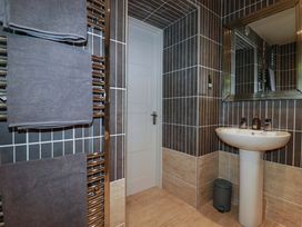 A bathroom with a sink and towel warmer at Sea View in St Austell