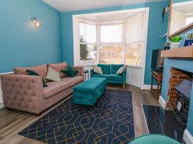 A living room with a sofa and footstool at The Old Post Office in Weymouth