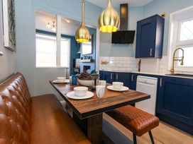 A dining area with a table and seating at The Old Post Office in Weymouth