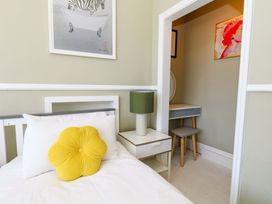 A bedroom with a bed and a desk at The Old Post Office in Weymouth