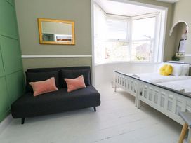 A bedroom with a sofa and a bed at The Old Post Office in Weymouth