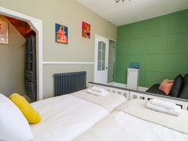 A bedroom with two beds and a sofa at The Old Post Office in Weymouth