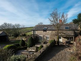 A house with a patio and trees at The Barley Crush in Bodmin Moor