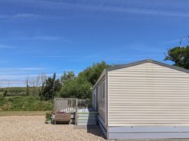 A mobile home with a deck and steps in Portesham