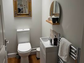 A bathroom with a sink, toilet, and mirror at The Annexe in Bridlington