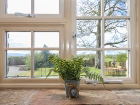 A window with a fern plant on the sill at Rainbow Cottage in Kirkby Stephen