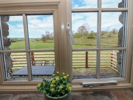 A window view showing a field and table at Rainbow Cottage in Kirkby Stephen