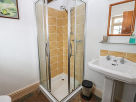 A bathroom with a shower and sink at Rainbow Cottage in Kirkby Stephen