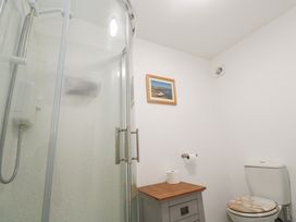 A bathroom with a shower and toilet at Sandyfeet Roskear Croft near Camborne